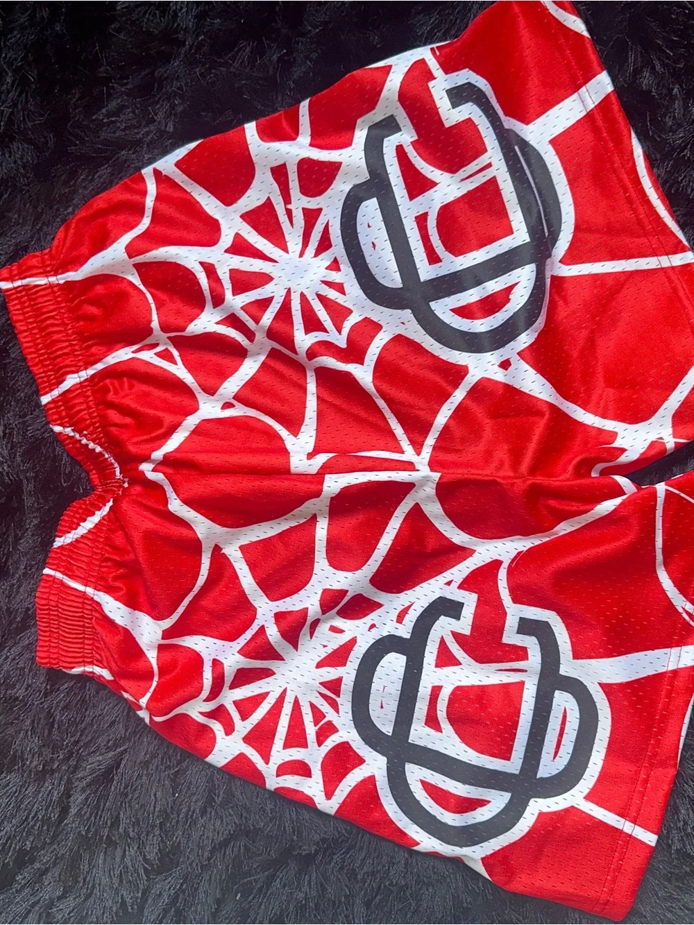 Men's Red Athletic Shorts with White Web Graphic